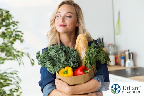 An image of a woman who is happy she chose cruciferous vegetables while shopping