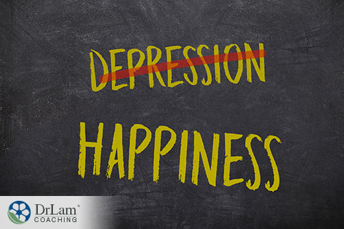 An image of a chalkboard with happiness and depression written on it with depression crossed out