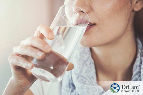 An image of a woman drinking a glass of water