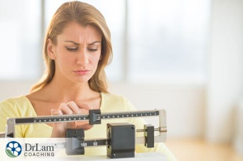 An image of a woman weighing herself