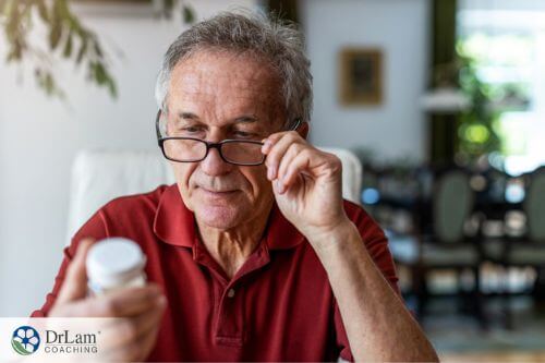 An image of a man looking at a bottle of supplements