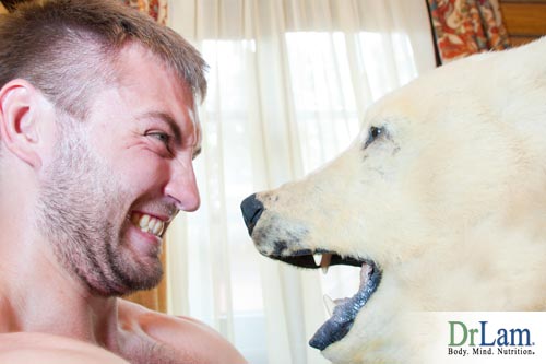 Closeup of a man and a bear head staring at each other, the effects of what does adrenaline do apply in this situation