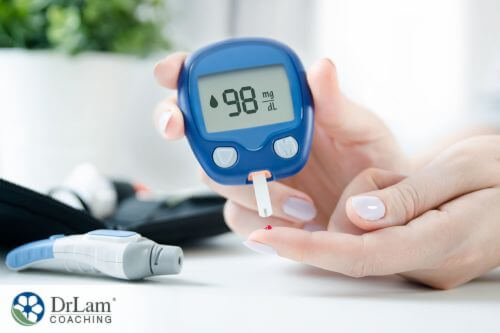 An image of using lancelet and glucometer to check the blood sugar level