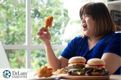 An image of a overweight woman eating fried chicken