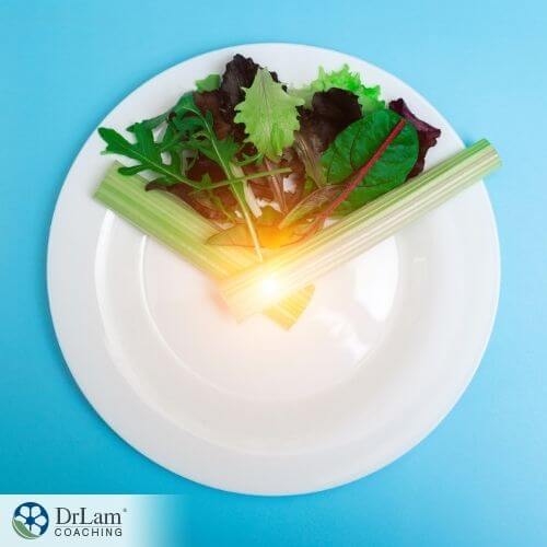 An image of a plate with salad and celery stalks on it