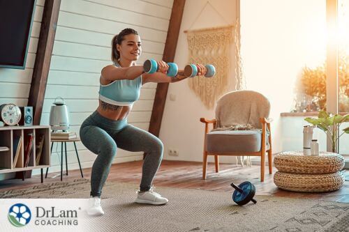 An image of a woman exercising with dumbbells