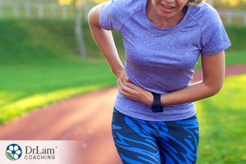 An image of a woman running while holding her side in pain