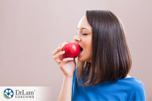 An image of a woman eating an apple