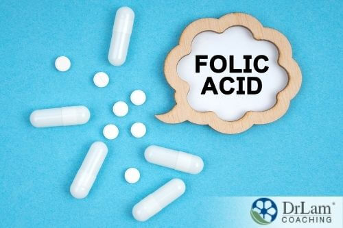 An image of white capsules and tablets saying Folic Acid