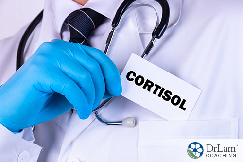 An image of a doctor putting a white card with cortisol written on it into his pocket