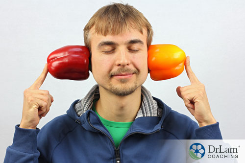 An image of a middle-aged man with bell peppers on his ears