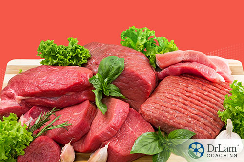 An image of different cuts of beef with herbs and lettuce