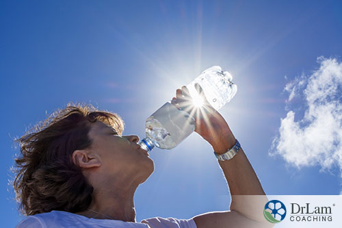 An image of a woman drinking a bottle of water