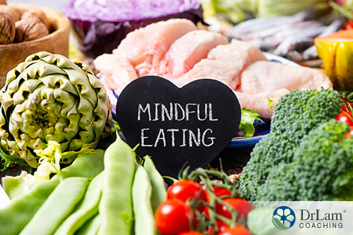 An image of healthy food with a heart shaped sign with mindful eating written on it