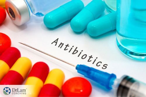 An image of a syringe and capsules with the word antibiotics