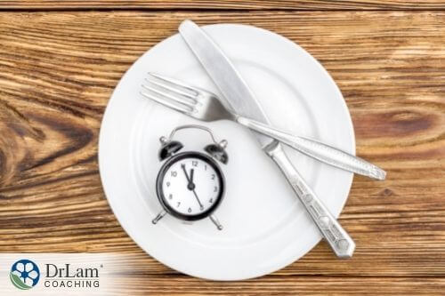 An image of a clock and kitchen utensils on a plate