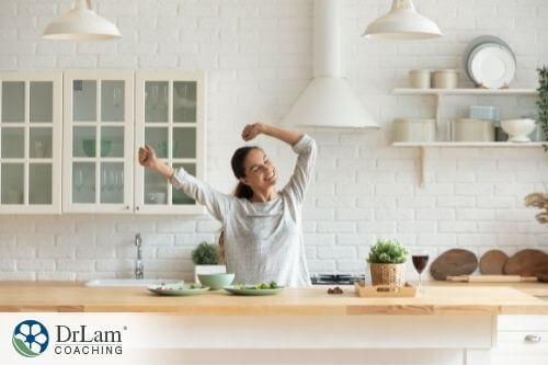 An image of a woman stretching behind the kitchen counter