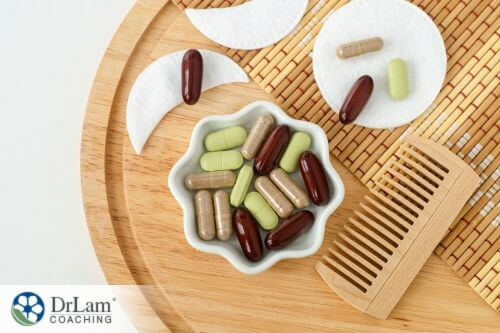 An image of vitamins in a dish next to a comb