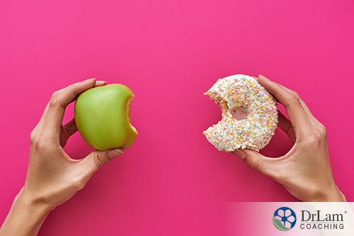 An image of someone holding up an apple in one hand and a doughnut in the other with a bite taken from each