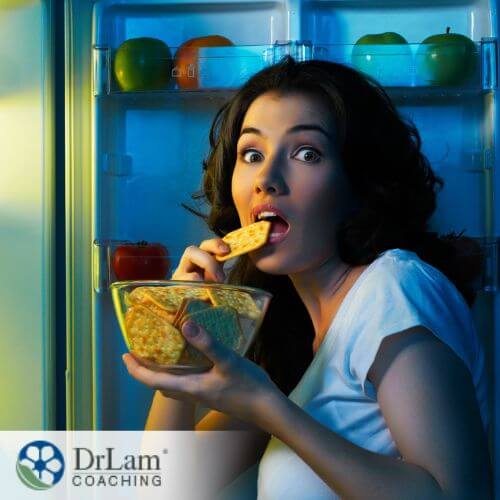 An image of a woman caught eating a bowl of crackers at night