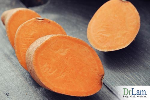 Image of several sweet potatoes, one sliced, to use in a healthy sweet potato recipe