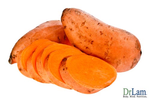 A few sweet potatoes, one of them sliced. Using them in a healthy sweet potato recipe is one way to gain extra nutrition.