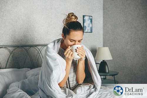 An image of a woman sipping tea in bed