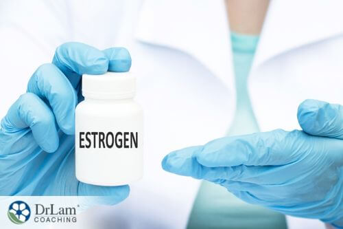 An image of a doctor holding a pill bottle of estrogen