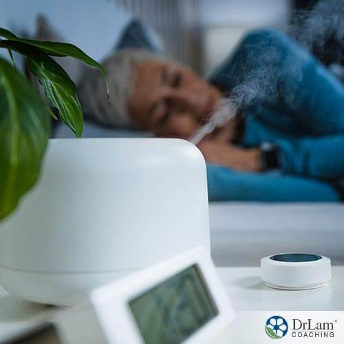 An image of an older woman sleeping with her humidifier going next to her bed