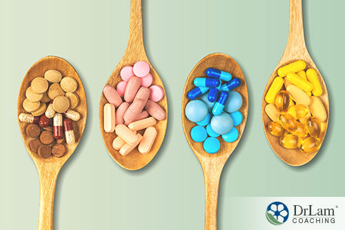 An image of four wooden spoons with different supplements in them