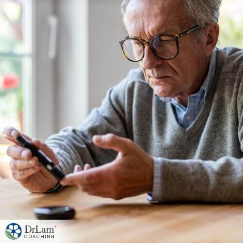 An image of an older man taking his blood glucose