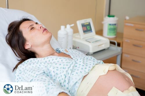 An image of a pregnant woman breathing while in labor