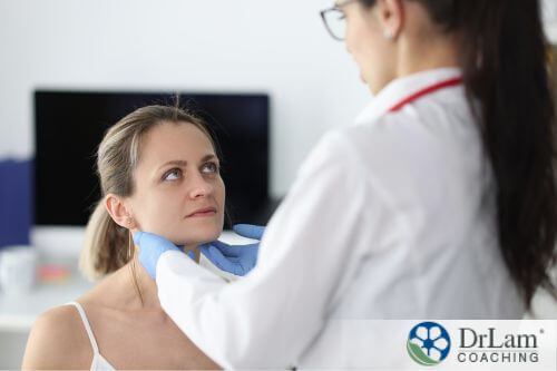An image of a woman having her thyroid examined by her doctor