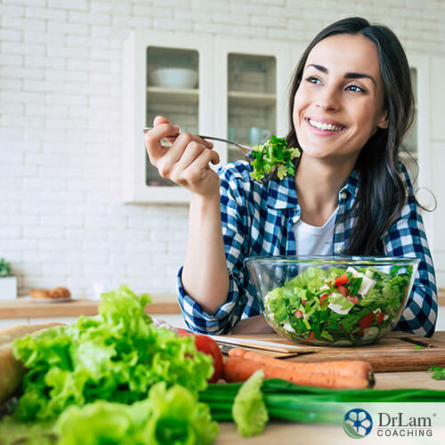 An image of a woman eating a salad