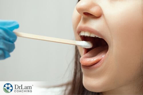 An image of a girl having a saliva swab test done