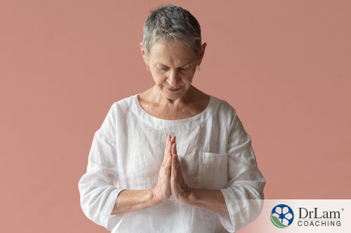 An image of an older woman meditating