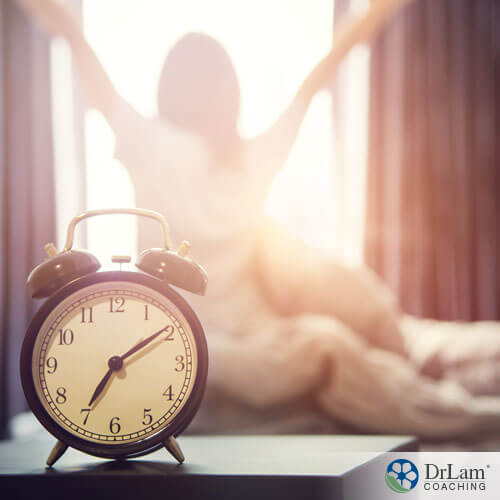 An image of an alarm clock and a woman stretching in the sunlight