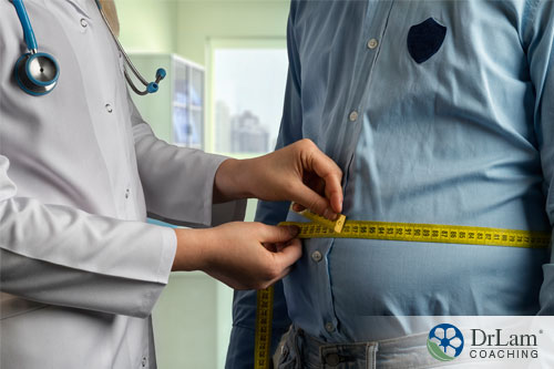 An image of an obese man being measured who needs help to increase testosterone