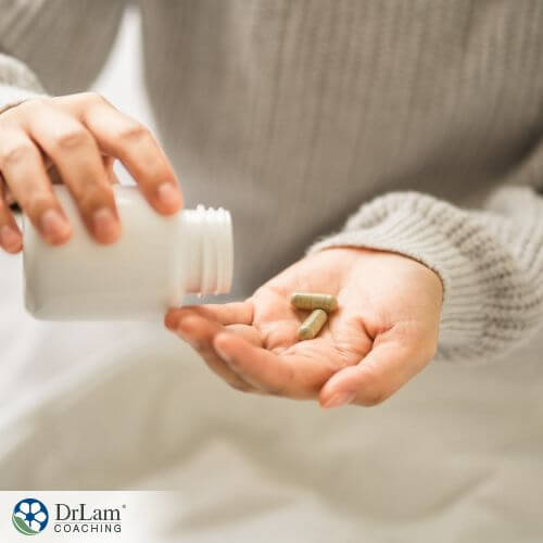 An image of a woman pouring capsules in her palm