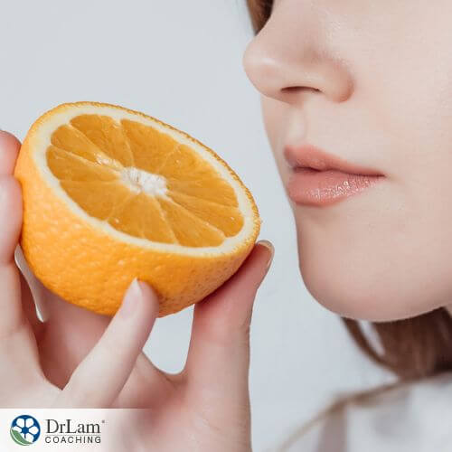 An image of a woman holding a sliced orange