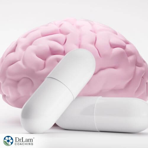 An image of a brain model surrounded by white pills for cognitive support