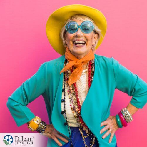 An image of an older woman smiling and wearing colorful clothing