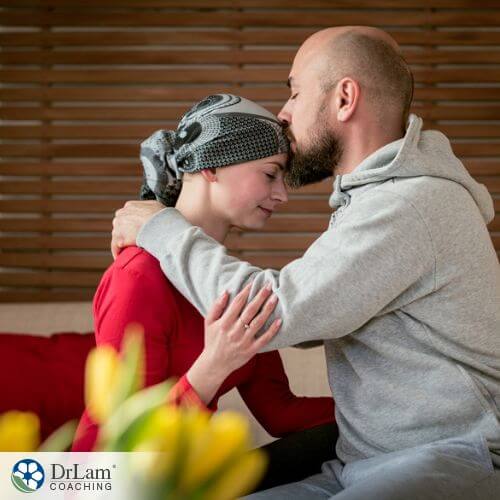 An image of a woman with early-onset cancer and a man kissing her forhead