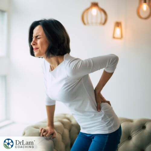 An image of a woman holding her lower back in pain