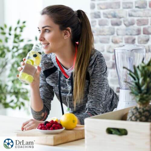 An image of a woman drinking a detoxing beverage