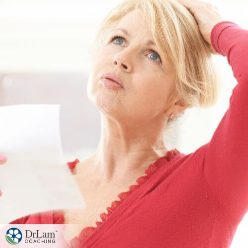 An image of a woman in Menopause fanning herself
