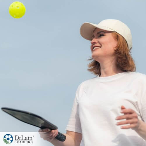An image of a woman playing a pickleball