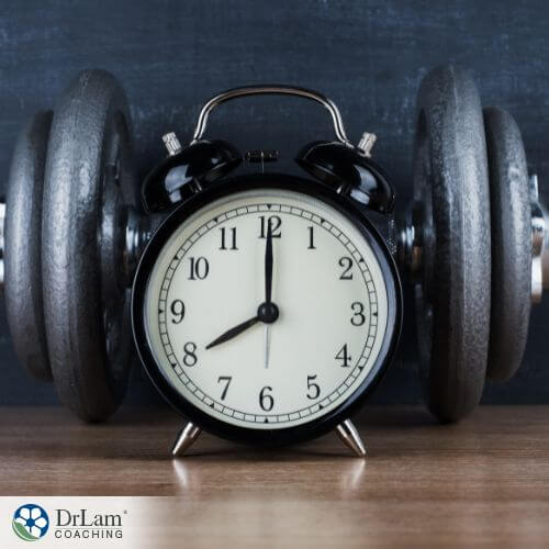 An image of an alarm clock and set of weights