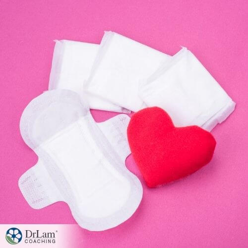 An image of sanitary napkins and a heart