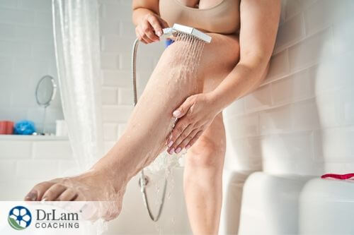 An image of a woman in the shower washing her legs